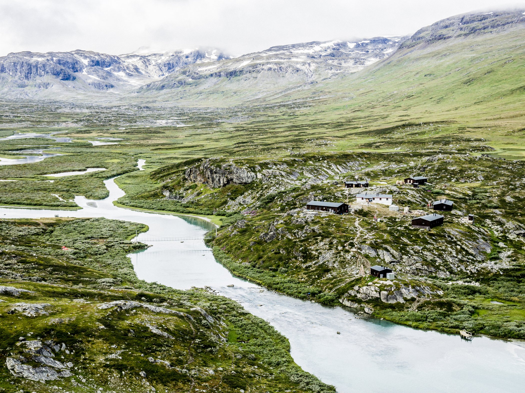 Mountain station beside a winding river in a mountain landscape.