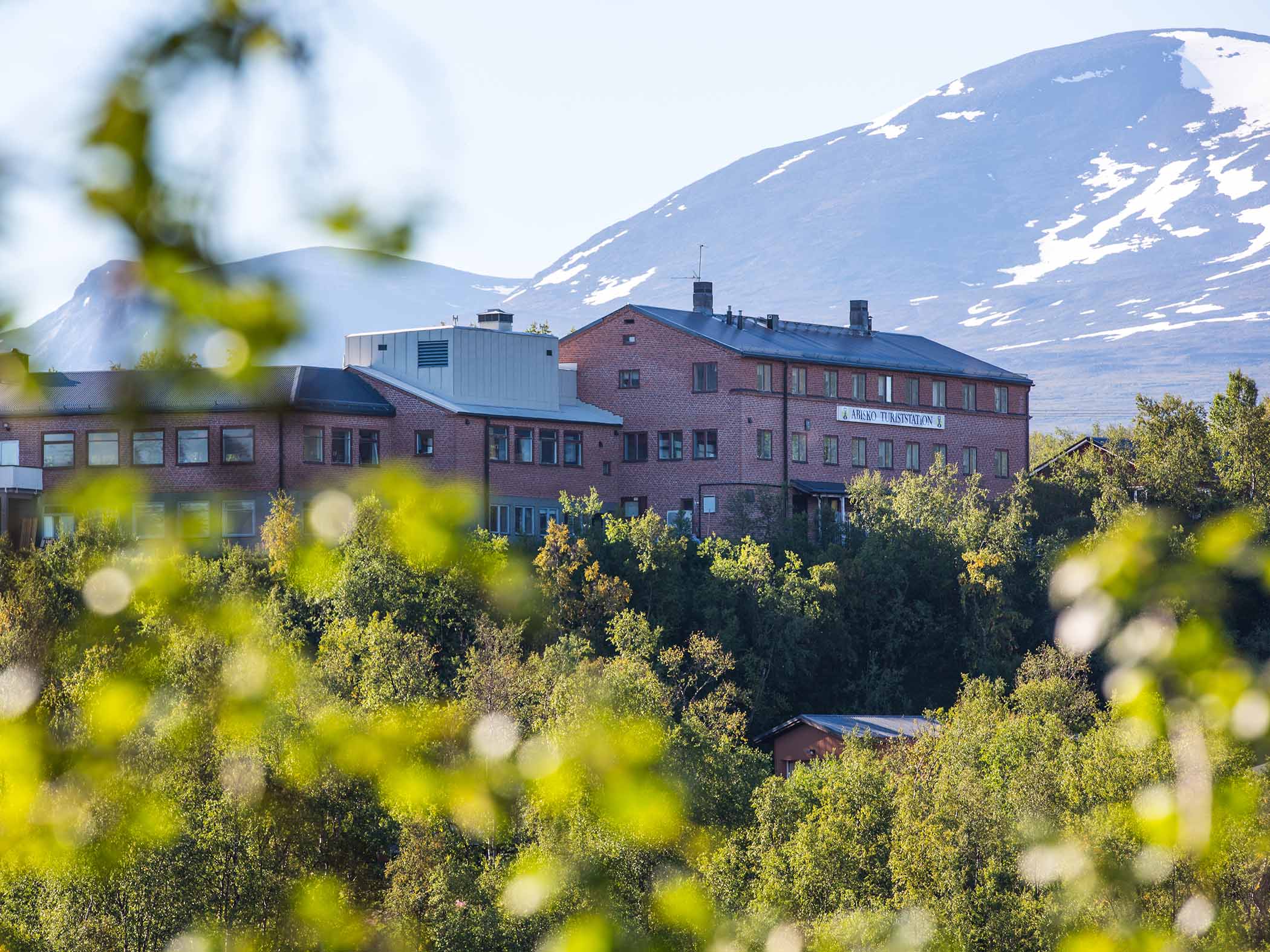 STF Abisko Tourist Station with mountains in the background.