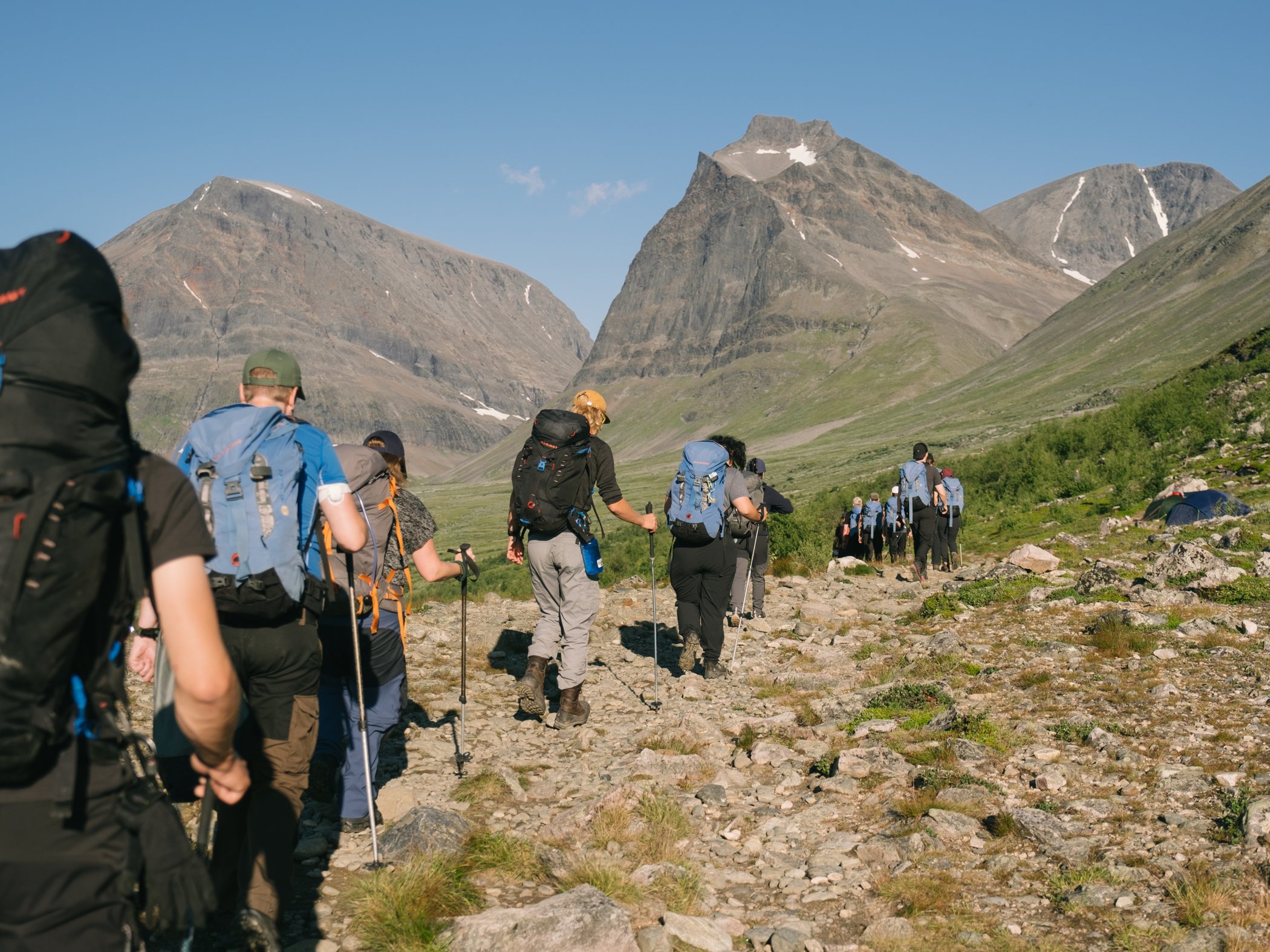 Hikers walking through a mountain valley near Kebnekaise.