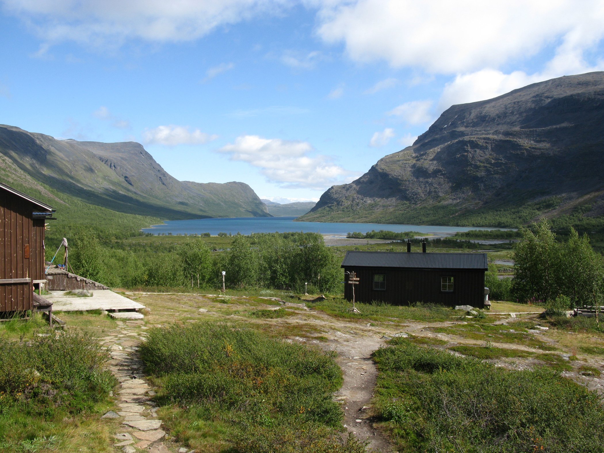View over Lake Kaitumjaure surrounded by mountains.
