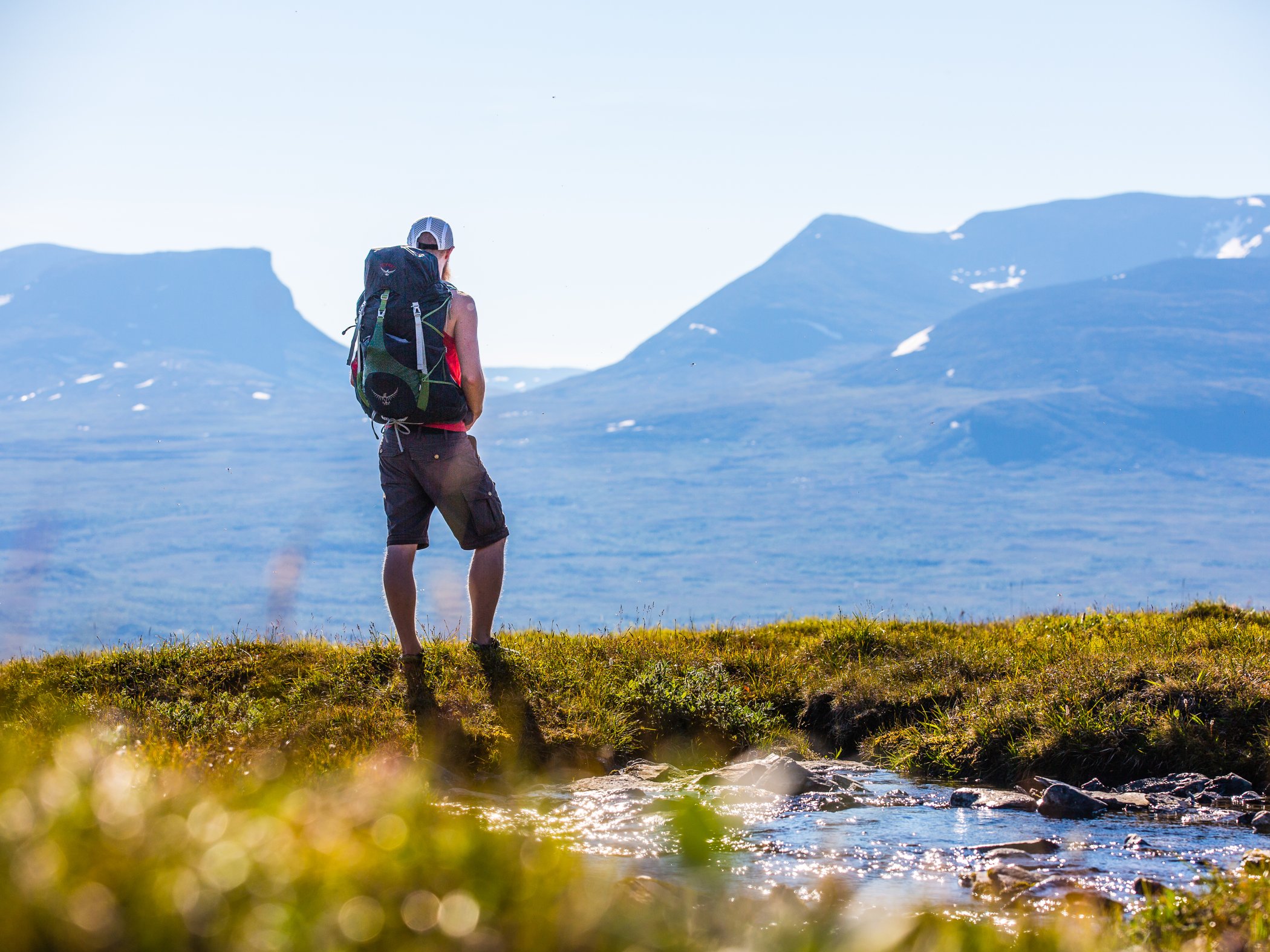Hiker overlooking a mountain landscape.