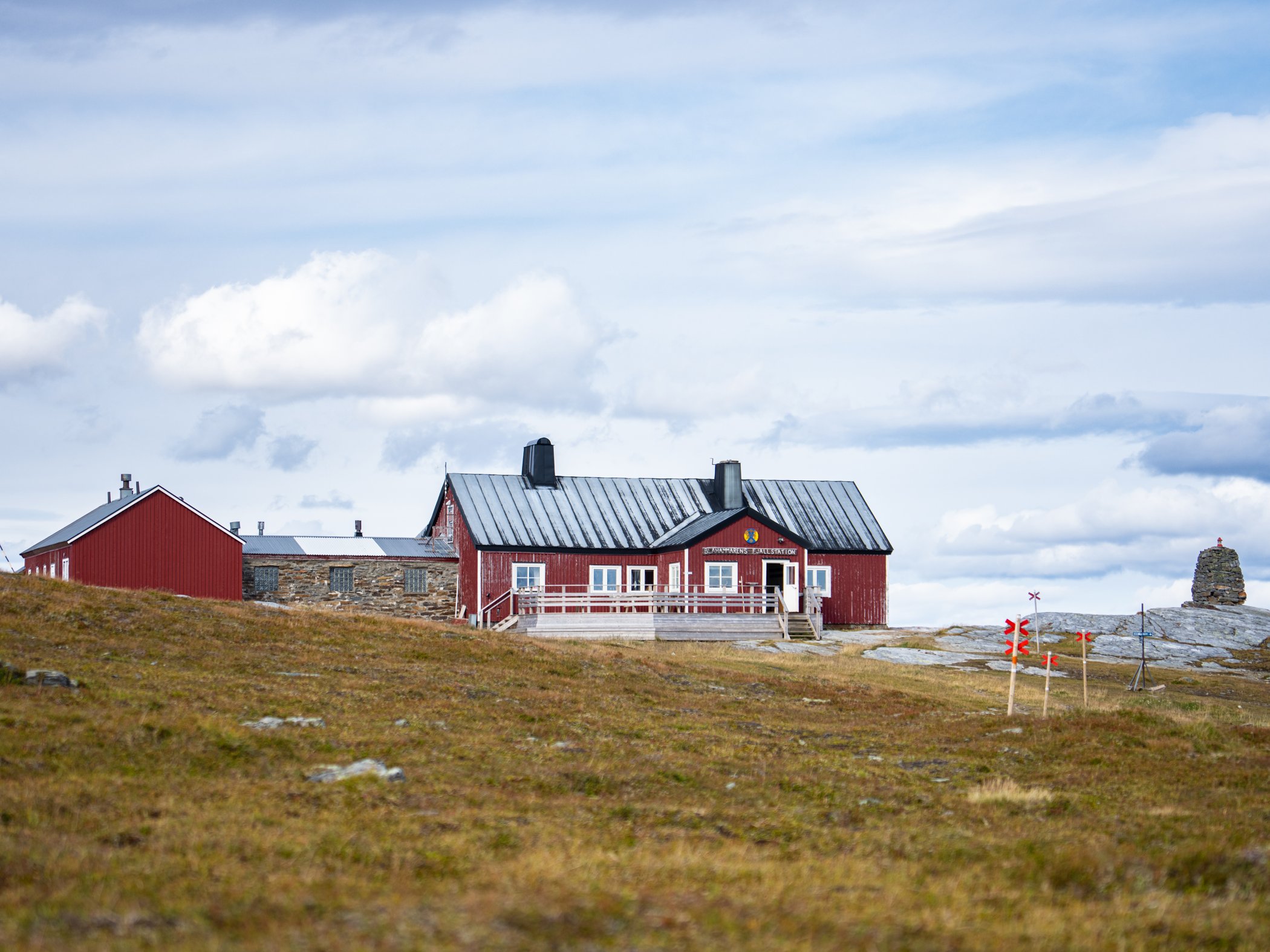 Mountain station on open fell terrain under a cloudy sky.