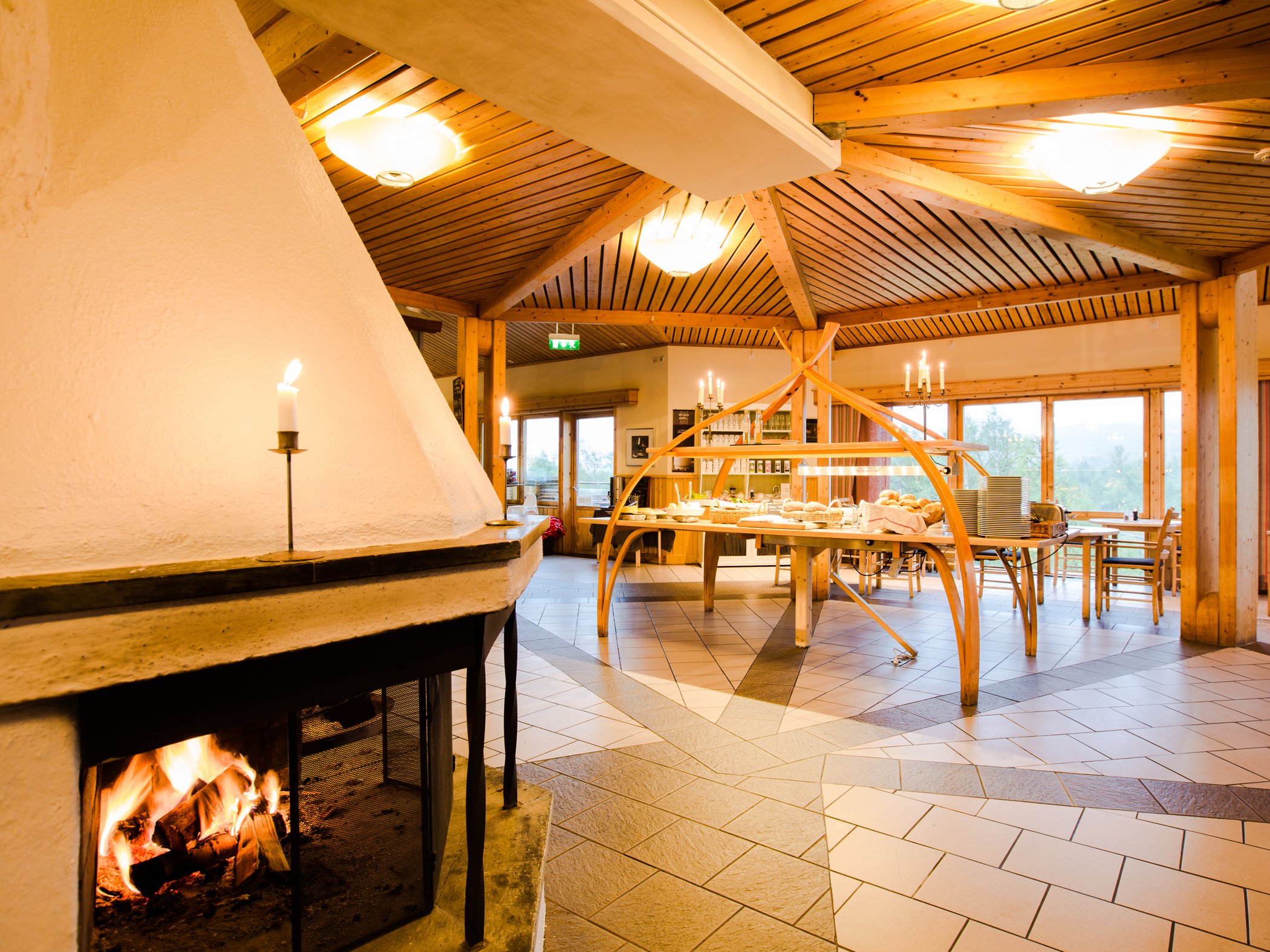 Cosy dining room with an open fireplace and buffet area.