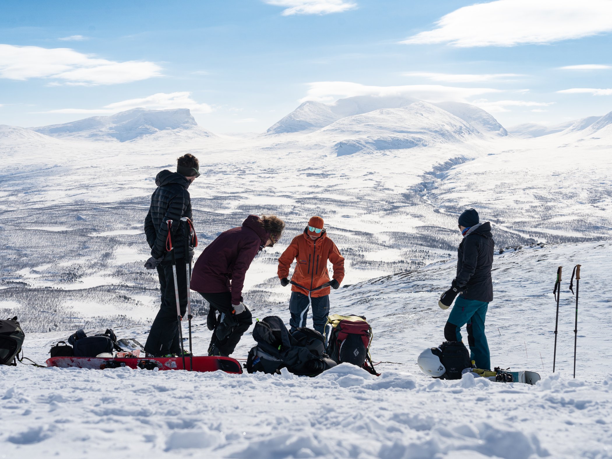 Group prepares for a ski touring excursion overlooking the snow-covered mountain landscape in Abisko.